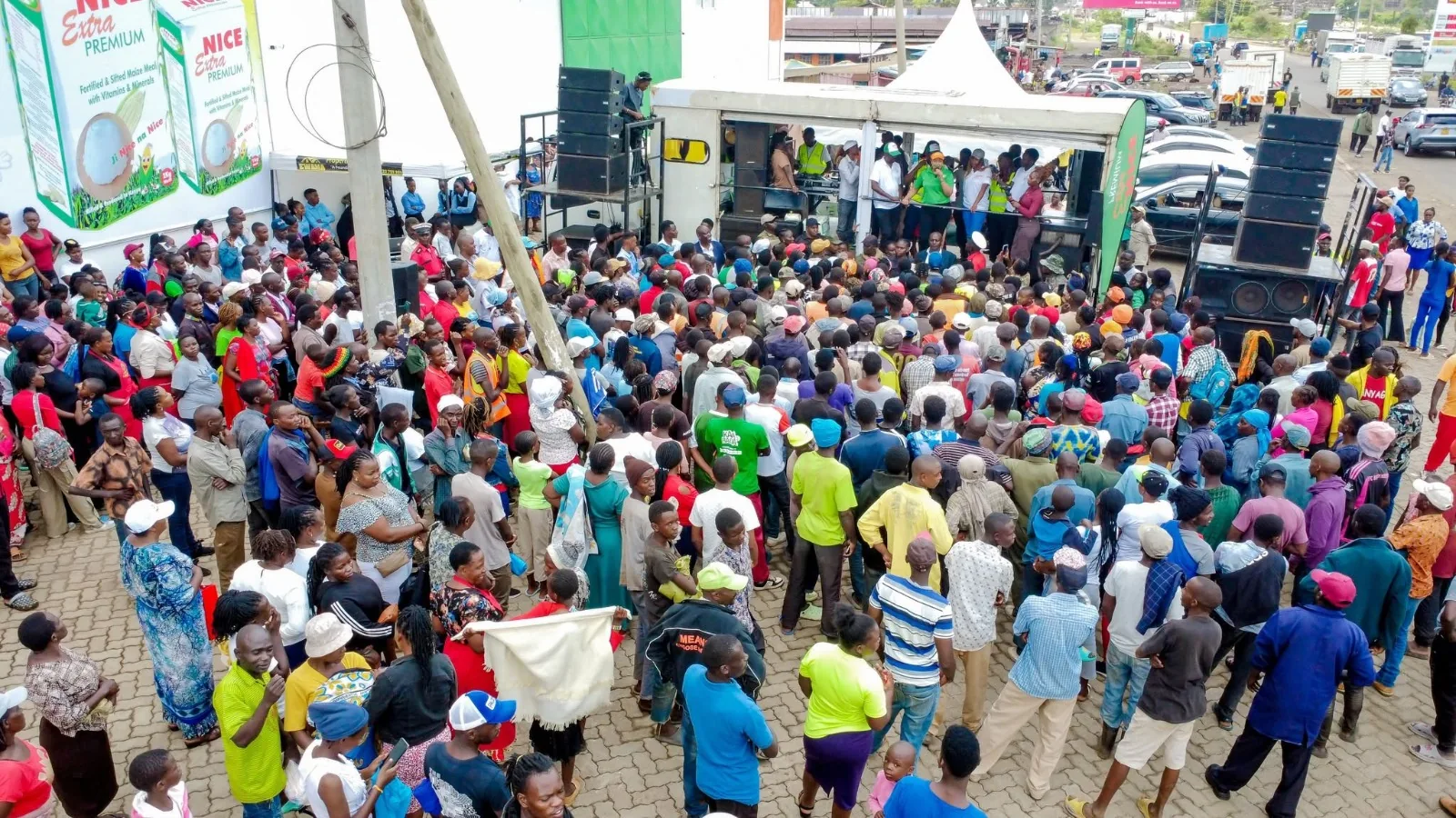 Large crowd of Kenyan farmers and residents gathered outdoors at a Nice Extra Premium event
